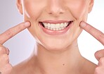 Mouth, dental and oral hygiene with a model woman in studio on a gray background for teeth whitening. Dentist, healthcare and veneers with a female indoor to show a happy smile at a tooth specialist