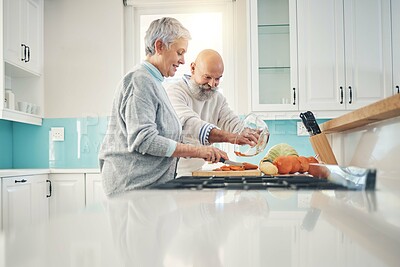 Buy stock photo Cooking, nutrition and a senior couple in the kitchen of their home together during retirement for meal preparation. Health, wellness or food with a mature man and woman making supper in their house
