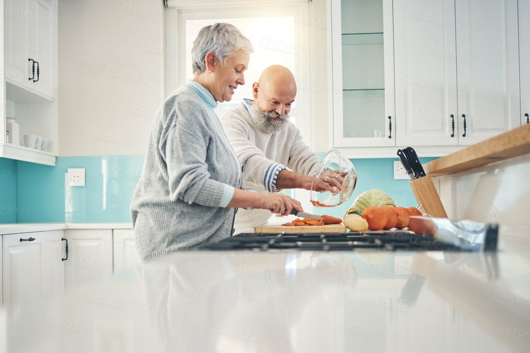 Buy stock photo Cooking, nutrition and a senior couple in the kitchen of their home together during retirement for meal preparation. Health, wellness or food with a mature man and woman making supper in their house