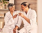 Couple, hotel and wine glasses for toast in massage, vacation or holiday celebration, love and romance. Champagne, excited and senior people for luxury, wellness and relax, hospitality service or spa