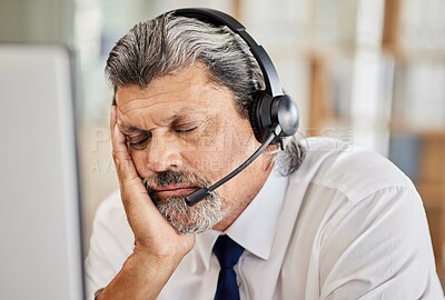 Buy stock photo Tired, call center and male consultant sleeping in his office while doing an online consultation. Exhausted, burnout and mature man telemarketing or customer support agent with a headset in workplace