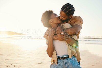 Buy stock photo Beach sunset, sunshine and black couple hug, kiss and enjoy time together, support and romance on travel holiday. Marriage, flare or hugging African people connect, care and bond on anniversary break