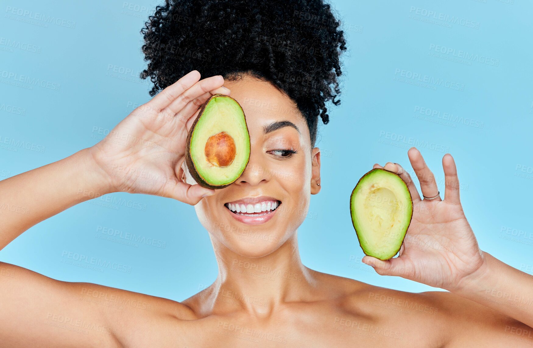 Buy stock photo Skincare, avocado and happy woman in studio for cosmetic, wellness and treatment on blue background. Beauty, fruit and female model smile with organic, dermatology or detox for glowing skin routine