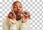 Face, kiss and donut with a black woman in studio on a golden ba