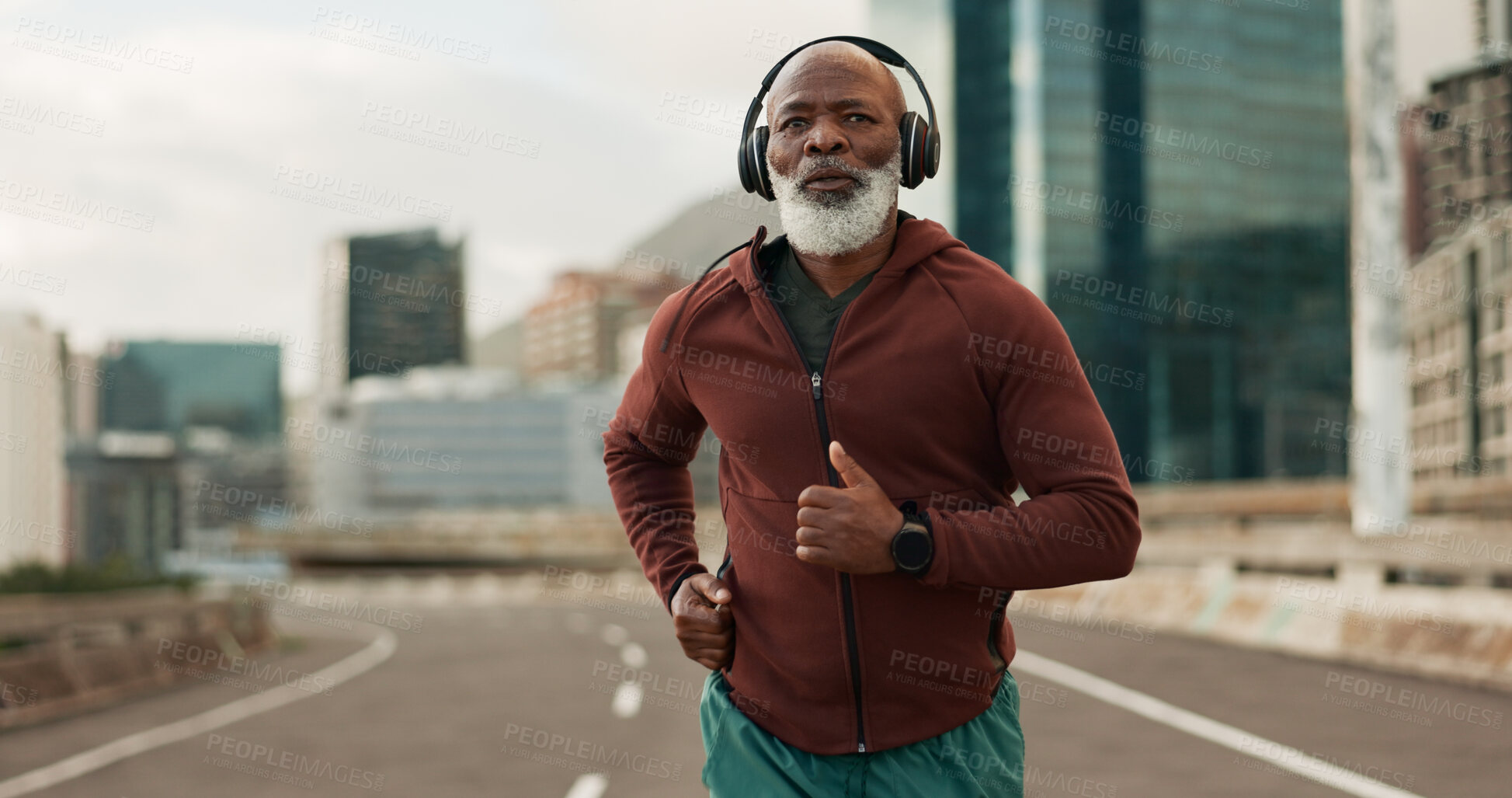 Buy stock photo Mature, person and running in city with headphones for fitness, workout and marathon training music. Black man, athlete or exercise podcast in South Africa for cardio wellness, health or sports radio