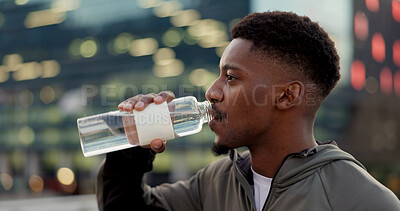 Buy stock photo Black man, drinking water and fitness in city after workout, exercise or outdoor training for natural sustainability. Thirsty African male person with mineral drink on break for hydration in town