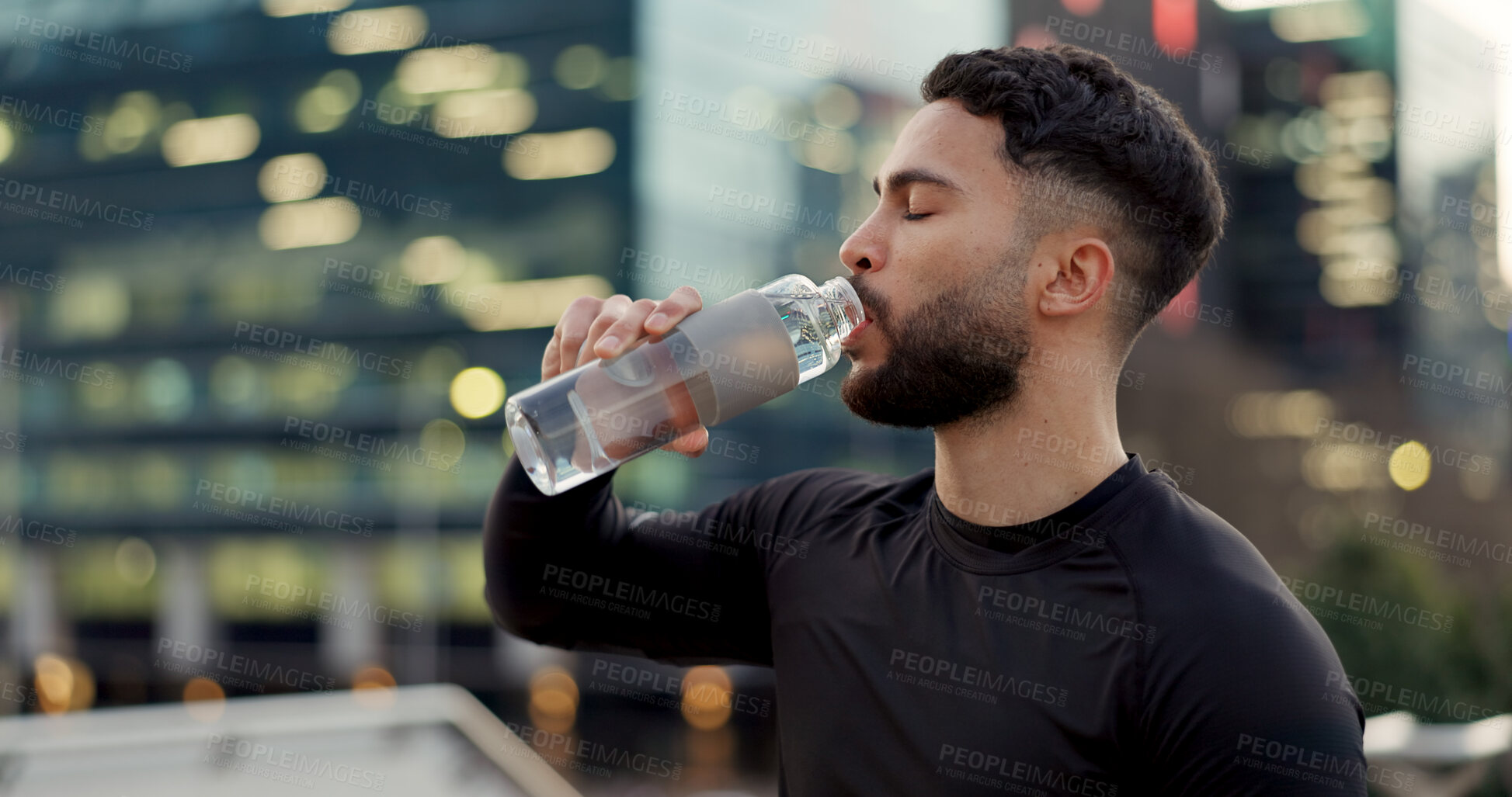 Buy stock photo Man, drinking water and fitness in city after workout, exercise or outdoor training for natural sustainability. Thirsty male person with mineral drink in rest, recovery or break for hydration in town