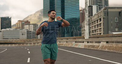 Buy stock photo Time, fitness and a man running in the city for sports training, getting ready for a marathon or race. Watch, exercise and a young runner or athlete outdoor in an urban town for his workout routine