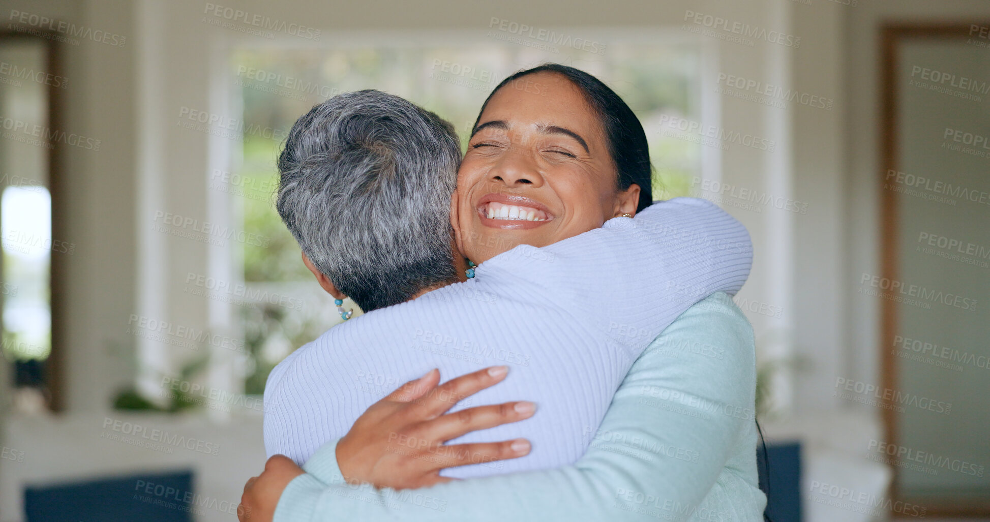 Buy stock photo Hug, love and senior mother and daughter in home for bonding, relationship and smile together. Family, happy and mature mom embrace adult woman for mothers day, support and care in living room