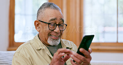 Buy stock photo Phone, smile and social media with a senior man on a sofa in the living room of his home for retirement. Relax, app and a happy elderly person in an apartment for communication on his mobile