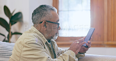 Buy stock photo Relax, home and senior man with a smartphone, internet and connection with social media in a lounge. Mature person, elderly guy and pensioner with a cellphone, digital app and communication with text