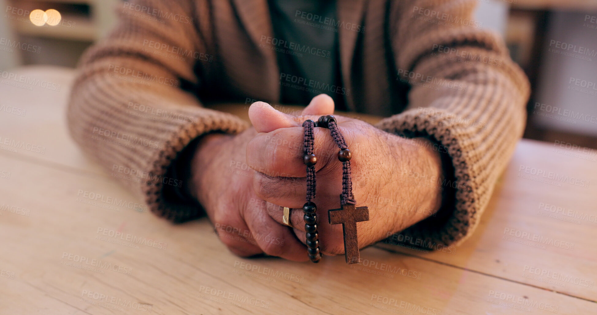 Buy stock photo Hands, rosary and cross with closeup for faith, peace and hope at desk, home or praying for worship. Person, crucifix and jewelry for religion, mindfulness and connection to holy spirit, Jesus or God