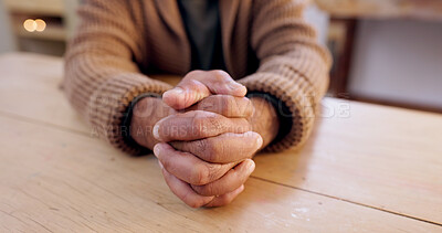 Buy stock photo Hands together, person and stress with table and problem from despair and praying. Anxiety, hope and issue in a retirement home with grief, religion and challenge at a house with worry or gratitude