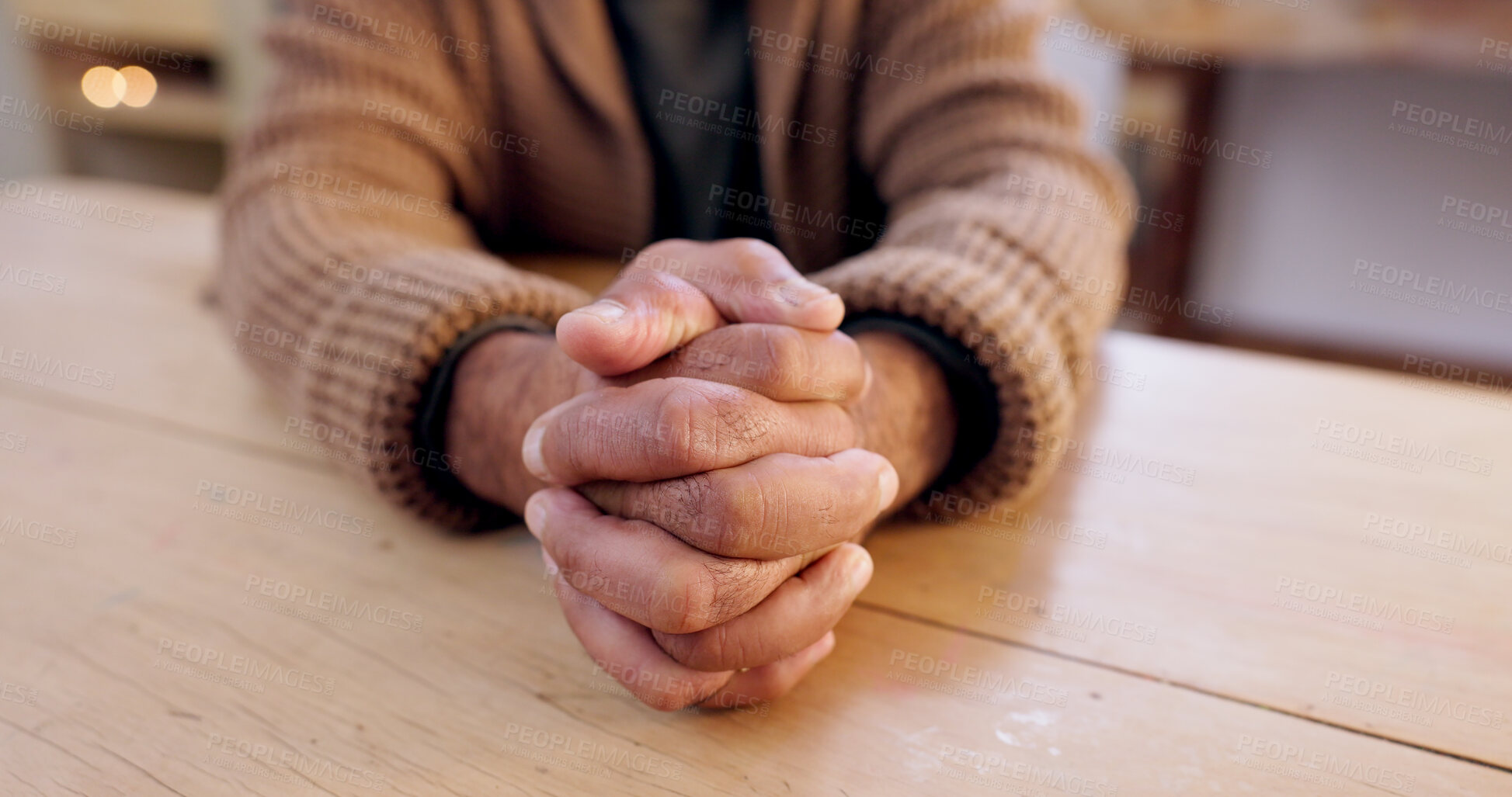 Buy stock photo Hands together, person and stress with table and problem from despair and praying. Anxiety, hope and issue in a retirement home with grief, religion and challenge at a house with worry or gratitude