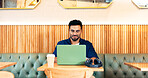 Man in coffee shop, typing on laptop and remote work, reading email and writing blog, article and research in restaurant. Computer, freelancer and editor in cafe, store and technology for internet