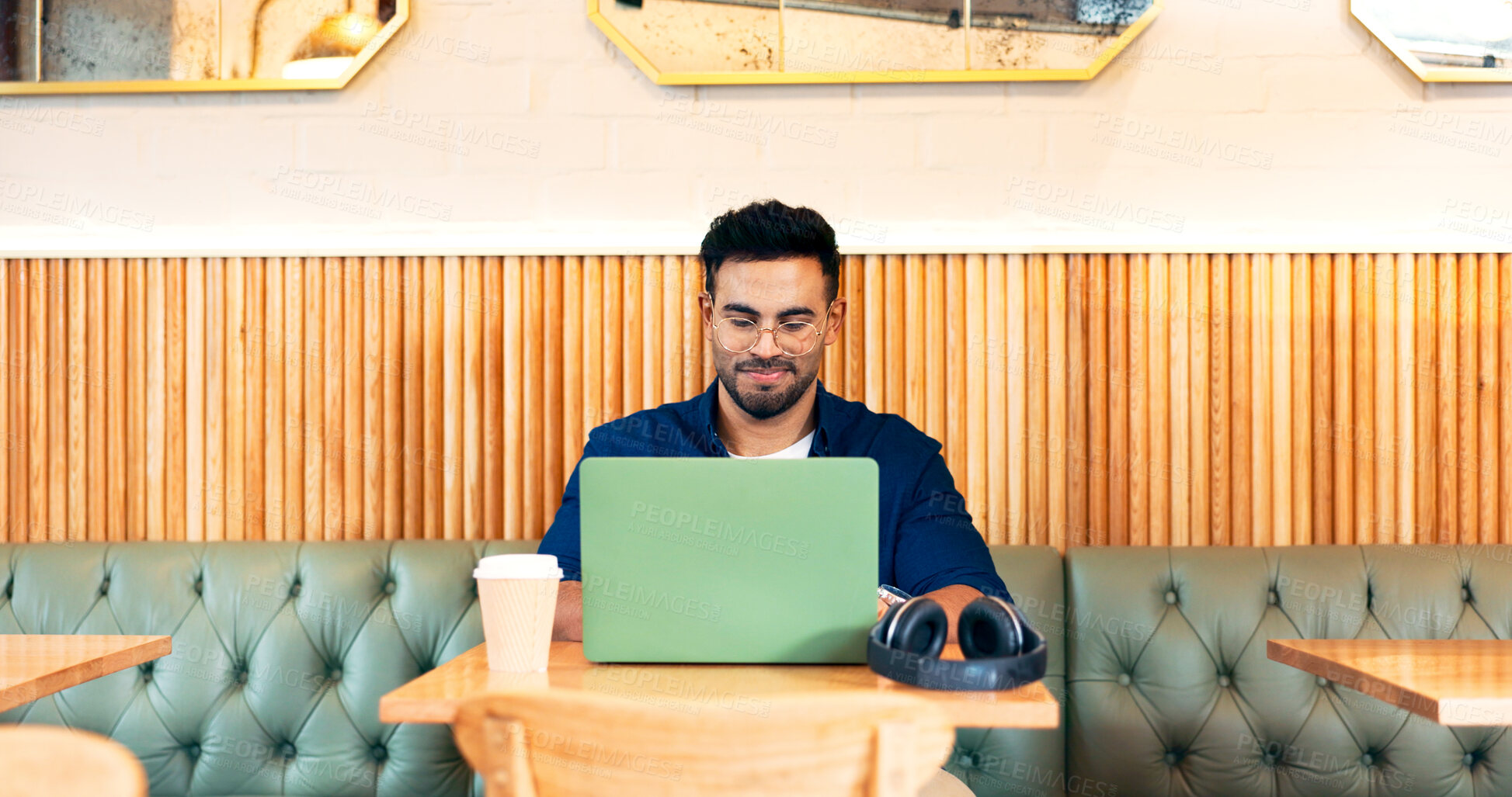 Buy stock photo Man in coffee shop, typing on laptop and remote work, reading email and writing blog, article and research in restaurant. Computer, freelancer and editor in cafe, store and technology for internet