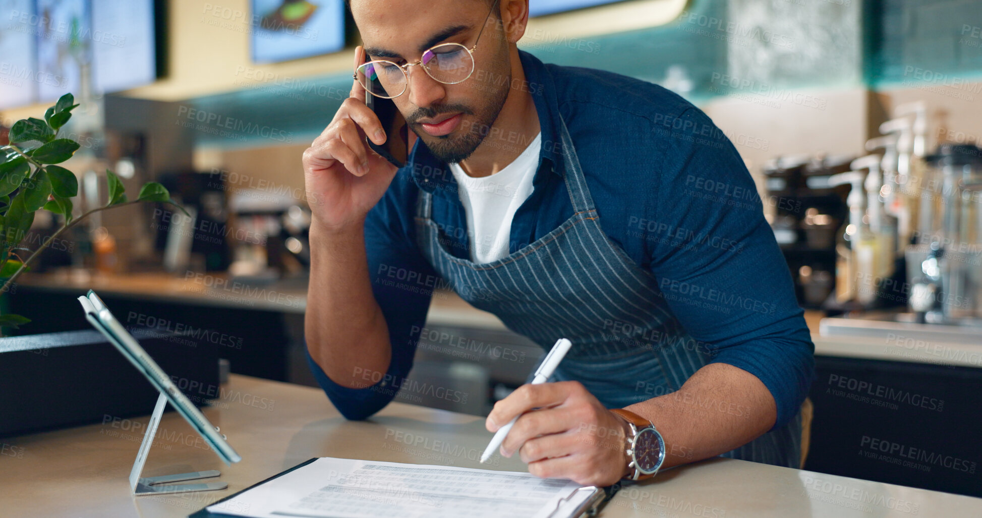 Buy stock photo Barista, phone call and paperwork for restaurant, cafe logistics or coffee shop management. Supply chain checklist, manager writing or man in mobile communication for stock inventory in startup 
