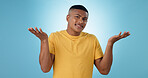 Confused, shrug and man portrait in studio with why hands on blue background space. Doubt, face and model with dont know emoji for choice, decision or palm scale, questions or asking body language