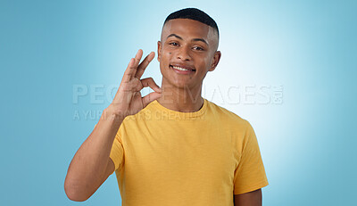 Buy stock photo Portrait, smile and man with perfect hand in studio with feedback, support or motivation on blue background. Ok, emoji and face of male model with vote for success, thank you or review excellence