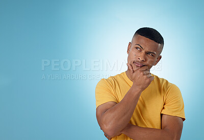 Buy stock photo Man, face and thinking of ideas at space in studio for planning insight, future decision and inspiration on mockup blue background. Curious model brainstorming solution, remember memory and questions