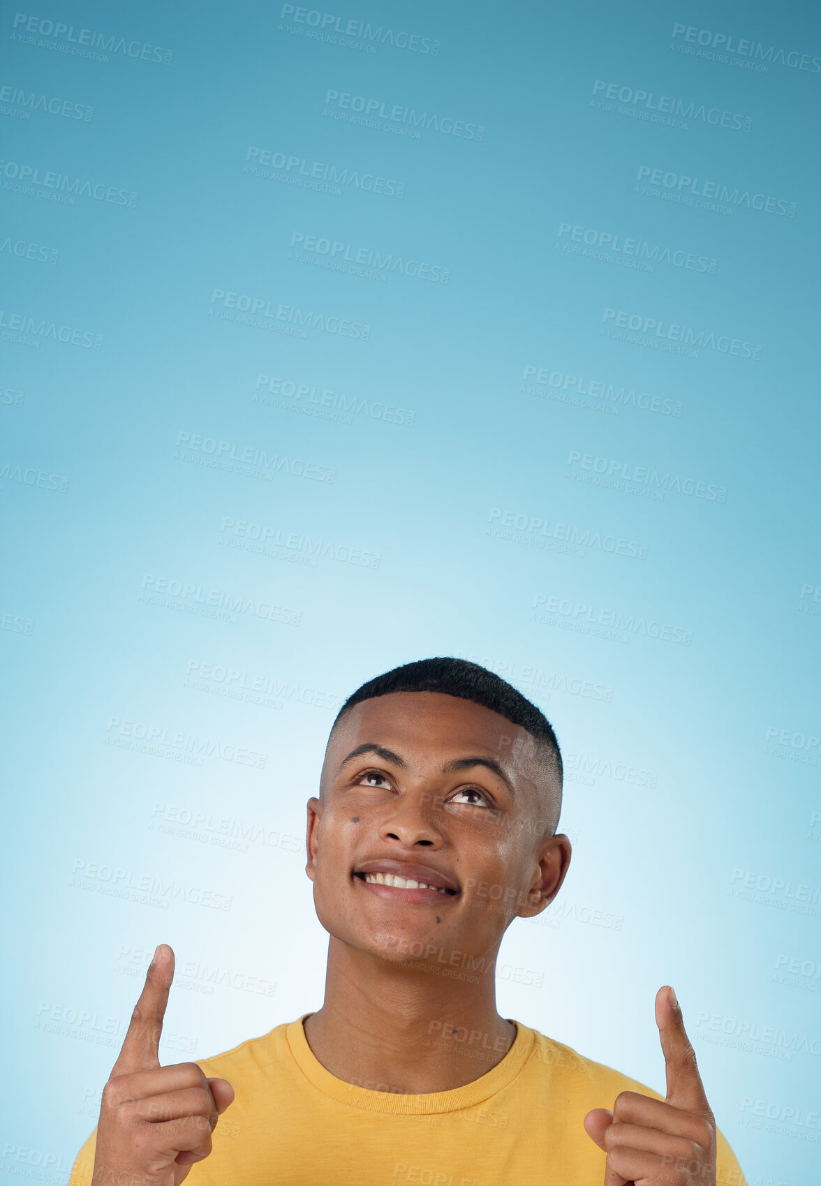 Buy stock photo Man, face and pointing up to space in studio for advertising choice, decision or information about us on blue background. Happy model, thinking and show presentation of mockup, ideas and announcement