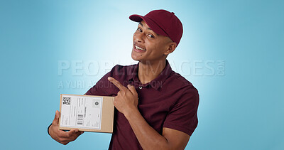 Buy stock photo Portrait, happy man and courier for pointing in studio with mock up for announcement on blue background. Cape Town, male model and smile for presentation of alert, promotion or notification in space