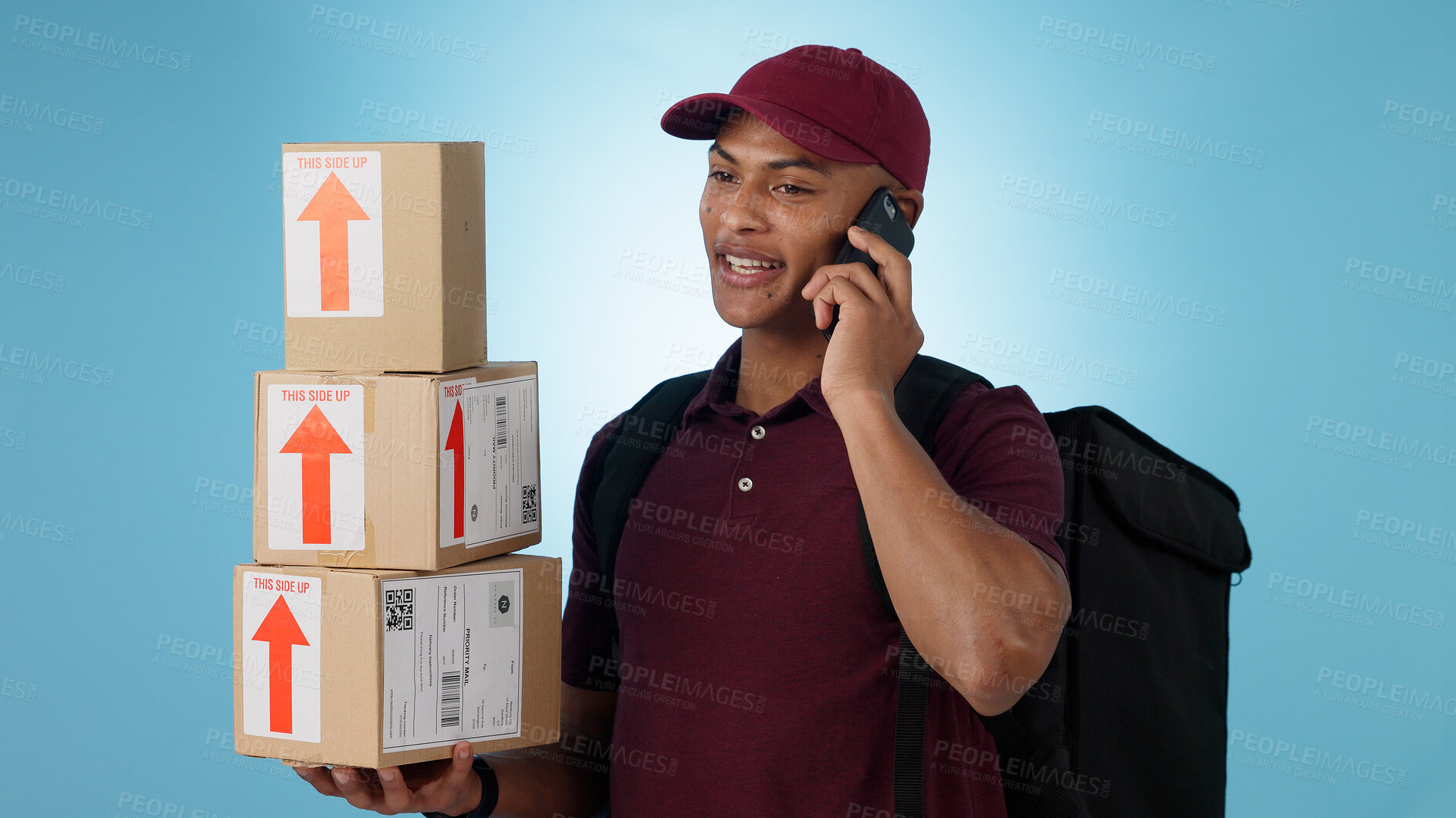 Buy stock photo Delivery man, boxes and phone call for courier communication, e commerce information and update on package. Worker or logistics supplier mobile chat for customer service on a blue, studio background