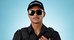 Security guard, portrait and man in studio with glasses for surveillance, justice and law enforcement on blue background. Serious bodyguard for crime prevention, safety patrol and monitoring danger 