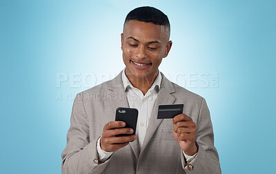 Buy stock photo Business man, credit card and phone in studio for ecommerce, financial accounting or banking investment on blue background. Happy worker, mobile and fintech for online shopping, stock trading or deal