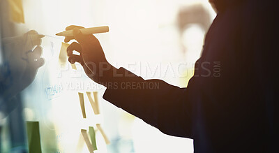 Buy stock photo Cropped shot of a businessman writing notes on a glass wall in an office