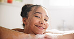 Happy, peace and face of a woman in a bath at her home for calm, relaxing and self care routine. Smile, headshot and portrait of young female person from Mexico with mindfulness in a tub in bathroom.