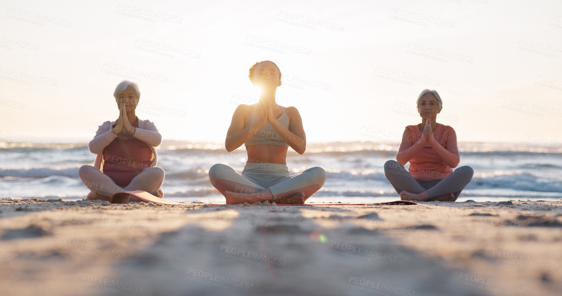 Buy stock photo Beach yoga class, sunset and meditation instructor coaching zen mindset, spiritual chakra healing or breathing exercise. Freedom, calm and people learning pilates, training and coach teaching group