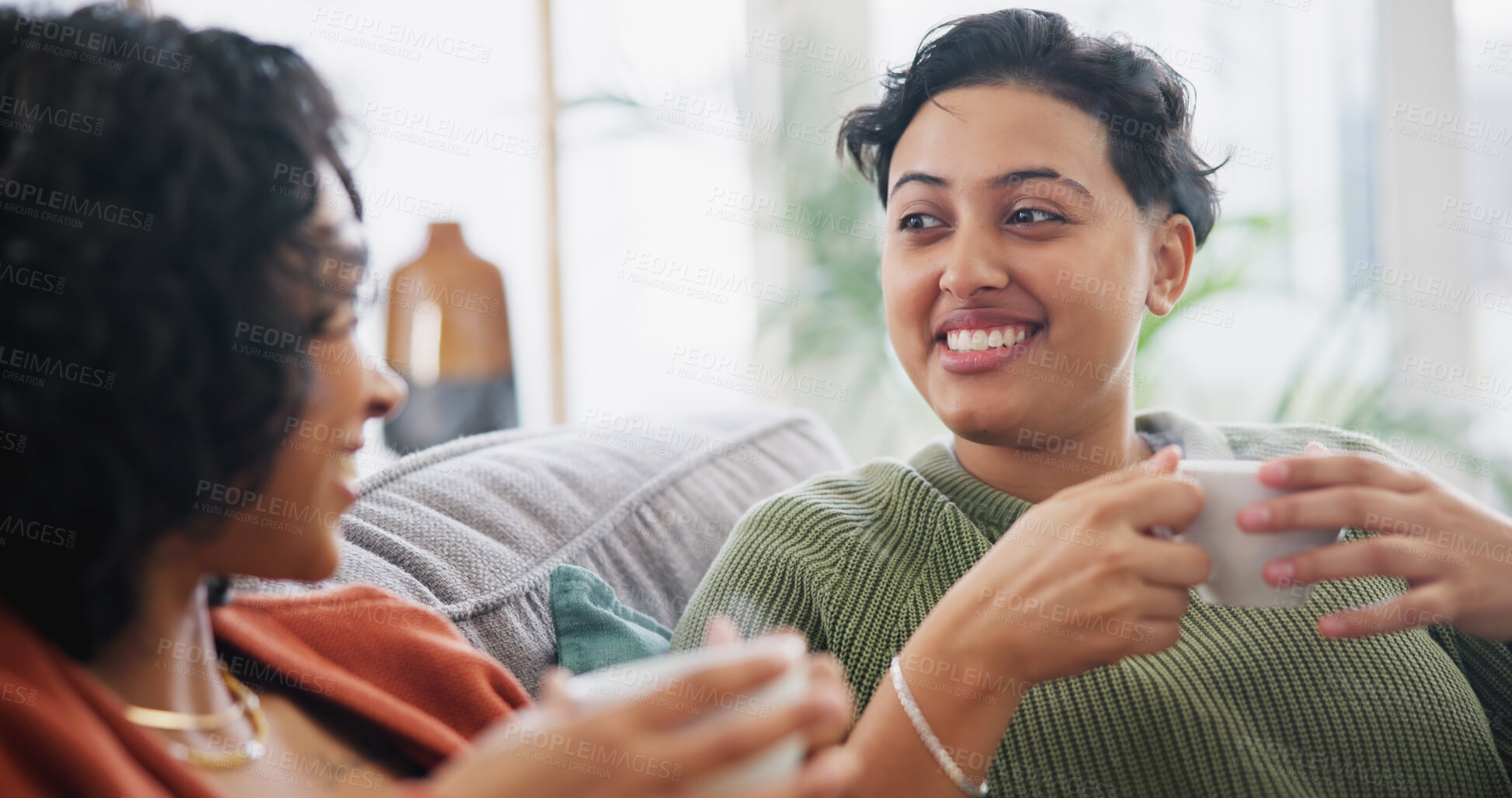 Buy stock photo Lesbian couple, coffee and women talking on sofa in home for bonding, connection and relax together. Love, lgbtq and happy people drinking tea in living room for chatting, discussion and conversation