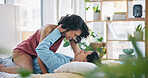Bed, fun and couple in a home with love and care together with a smile from playing. Funny, young people and bedroom with marriage in a house holding hands in the morning with a woman and a man