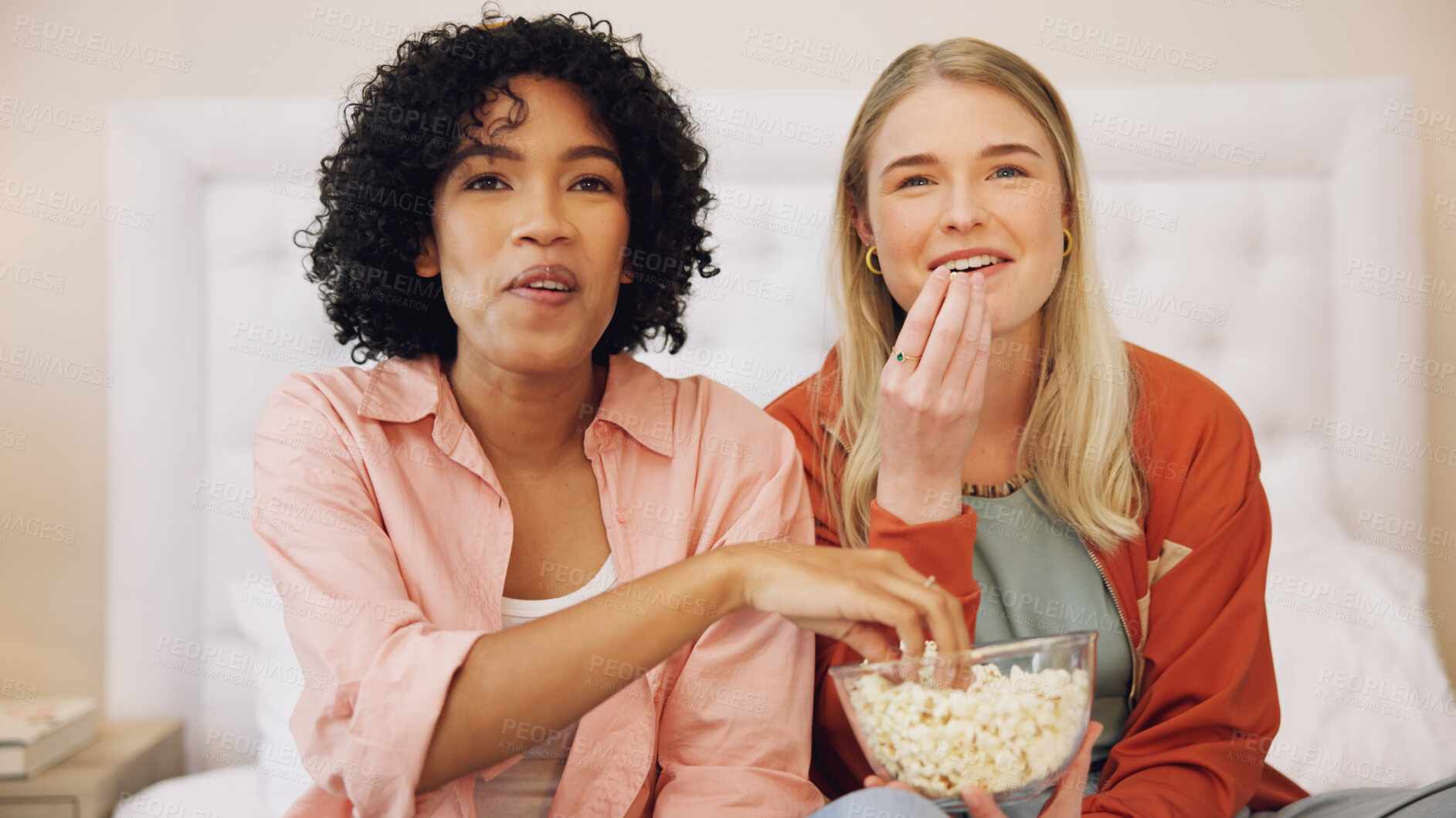 Buy stock photo Television, happy and women friends on a bed with popcorn for movie, comedy or standup show at home. Comic, snack and ladies watching tv in a bedroom laugh, bond and relax with streaming subscription