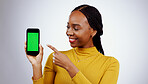 Woman, phone and green screen for presentation mockup, marketing and happy news on a white background. Young african person on mobile app, design space and opportunity with tracking marker in studio