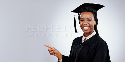 Graduation student, woman pointing and space for education, learning or college presentation in studio. Portrait of african graduate with information, registration steps or banner on white background