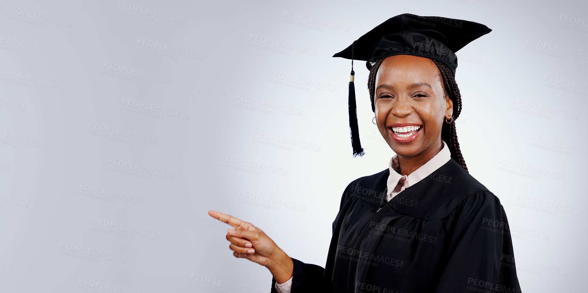 Buy stock photo Graduation student, woman pointing and space for education, learning or college presentation in studio. Portrait of african graduate with information, registration steps or banner on white background