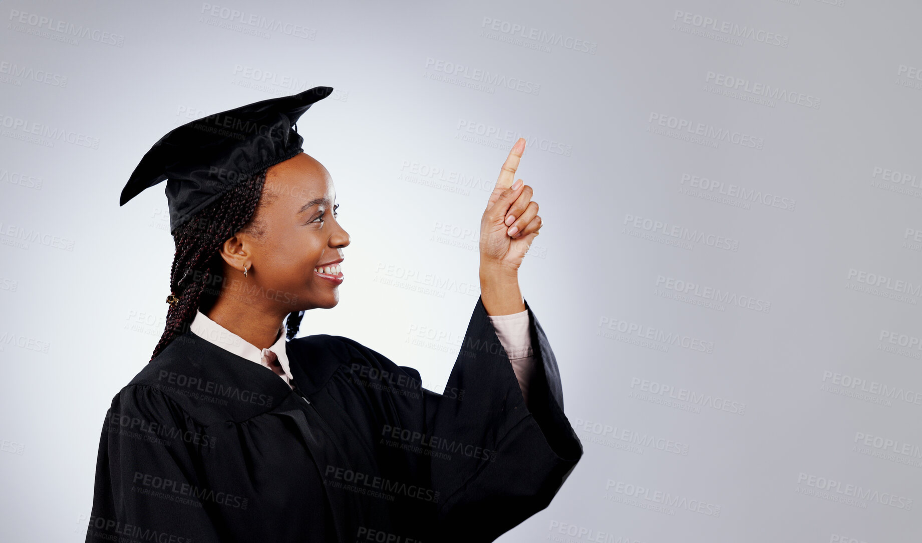 Buy stock photo Graduate, woman pointing up and space for education, learning or college presentation and study opportunity in studio. African student information, registration steps or offer on a white background