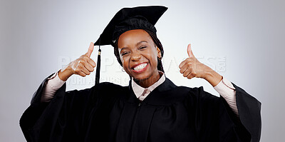 Graduation, thumbs up and woman or student success with celebration, education and learning or college achievement in studio. Portrait of happy african graduate with like emoji on a white background