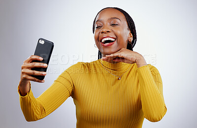 Buy stock photo Studio, happy or black woman taking selfie on social media with confidence, post or smile online. African lady, memory or face of influencer taking a photograph, vlog or picture on grey background