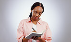 Woman, notebook and writing ideas, planning or creative solution for studying, college or education goals in studio. African student with book reminder and notes for learning or future plan in studio