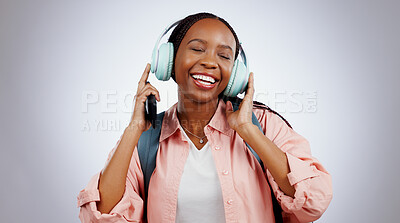 Music, student or happy black woman in studio listening to radio playlist to relax on grey background. Face, headphones or African person with smile singing or streaming a song audio or sound track