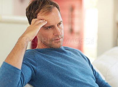 Buy stock photo Thinking, man and home on a living room sofa feeling stress and sad from being alone. House, lounge and couch with an angry male person with anxiety and headache from depression, idea and problem 
