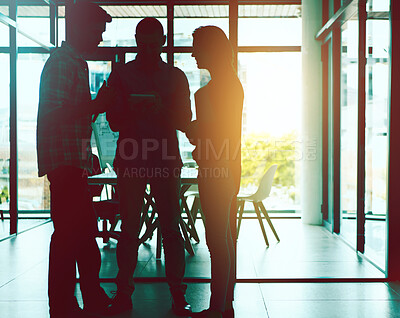 Buy stock photo Shot of colleagues working together in a modern office