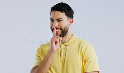 Buy stock photo Secret, happy man and portrait in studio for sign of privacy, surprise sales and confidential deal on white background. Indian model with finger on lips for quiet, gossip and emoji to whisper news