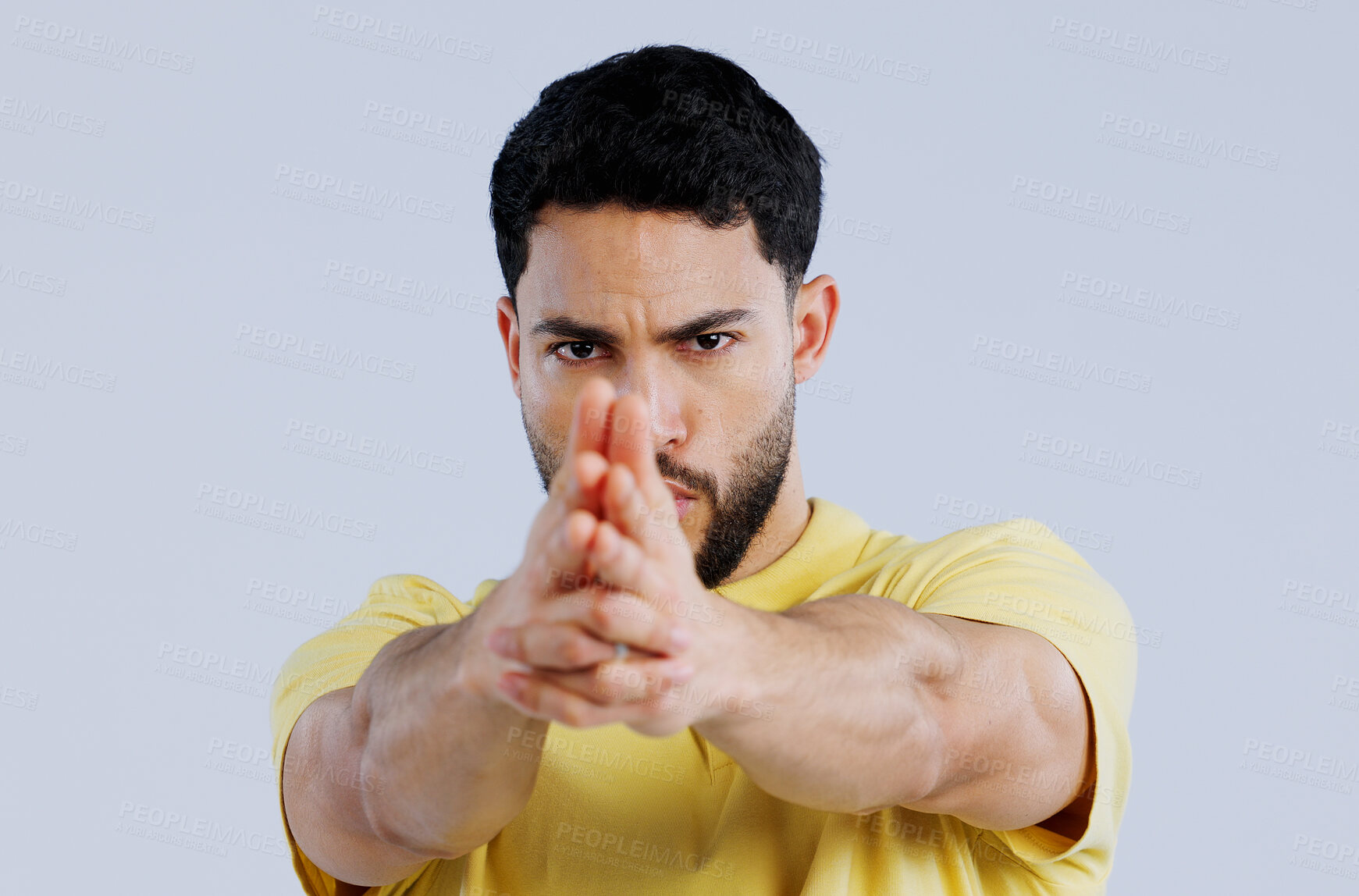 Buy stock photo Finger gun, pointing and portrait of man in studio with aim for target, shooting and spy on blue background. Secret agent, mockup space and face of person with hand gesture for pistol or weapon