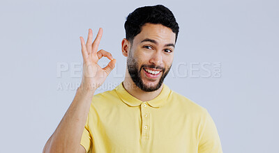 Buy stock photo Ok, sign and portrait of man in studio for vote, certified news and feedback on white background. Happy indian model with hand emoji for success, agreement and icon of support, review and excellence