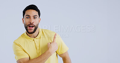 Buy stock photo Man, portrait and pointing up in surprise on mockup for deal, advertising or marketing against a gray studio background. Shocked or surprised male person or model showing notification, alert or sale