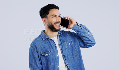 Man, phone call and communication in studio for contact, networking and funny conversation on white background. Happy young indian model, mobile discussion and laugh for chat, talking and connection
